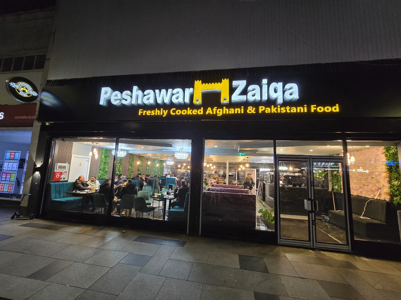Peshawar Zaiqa restaurant storefront in Slough at night